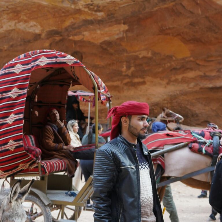 Traditional bedouin carriage in a desert landscape with rocky formations.